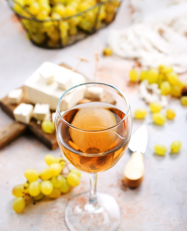 white wine and cheese on a table